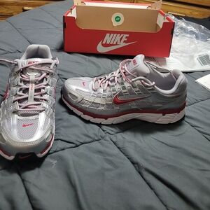 Nike Silver and Red Athletic Shoes. Men 8 1/2 = Women size 10. New In Box.